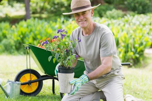 Professional garden maintenance service working on a Putney lawn
